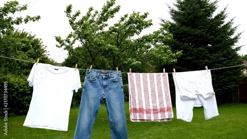 White laundry and denim on outdoor garden clothesline.