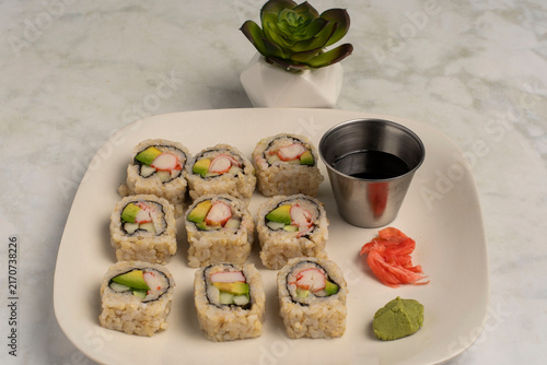 brown  rice sushi   served with soy sauce and wasabi