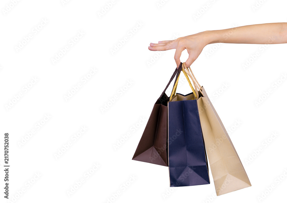 Naklejka premium Woman carrying blue and brown paper shopping bags isolated on white background, representing consumer spending, retail purchasing, customer lifestyle, seasonal sales and Black Friday shopping concept.
