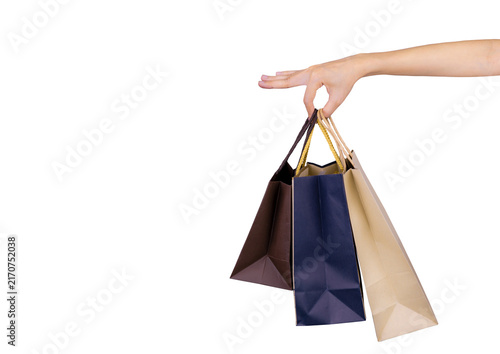 Woman carrying blue and brown paper shopping bags isolated on white background, representing consumer spending, retail purchasing, customer lifestyle, seasonal sales and Black Friday shopping concept.