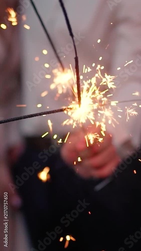 Sparklers explode during the evening celebration. People hold fireworks during the New Year's or Birthday celebration.