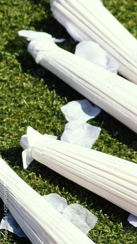 Stylish white vintage umbrellas provide shade from the hot, bright sun on a sunny summer day. Wedding ceremony for the bride and groom.
