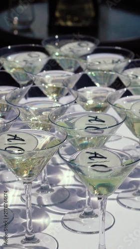 Glasses of sparkling wine shimmer in the sun outside during a festive event. Champagne is an alcoholic beverage at a banquet in an upscale restaurant.