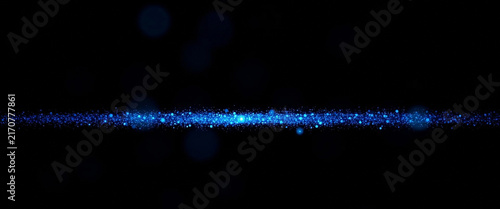 Abstract blue glitter particles background, glowing dust trail, sparkling light effect, magical stardust line, festive cosmic particles on black background