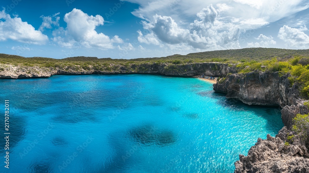 Obraz premium Panoramic view of an ocean lagoon with vivid blue waters surrounded by rugged cliffs and greenery