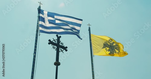 Greece national flag and Greek Orthodox Church flag waving in the wind