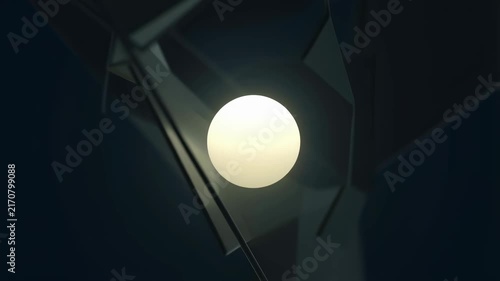 Glowing sphere rotates smoothly surrounded by reflective triangular planes in a dark abstract digital space. Layered dark blue and black tones enhance movement and depth.