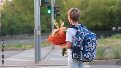 Cute blond child, boy with bouquet on first school day in Czech Republic