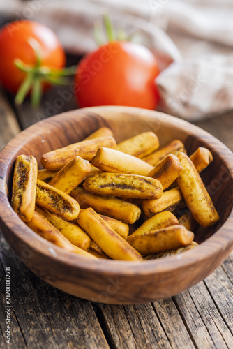 Rustic Herbed Stuffed Breadsticks and Fresh Tomatoes on Wooden Table Snack Scene
