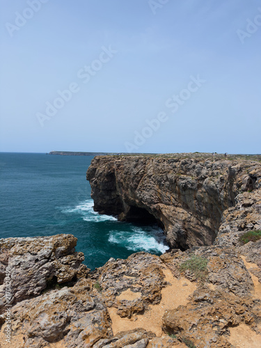 Photography Dramatic rocky cliffs and turquoise ocean at coastal headland