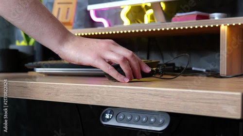 Person preparing home office desk and laptop for the workday