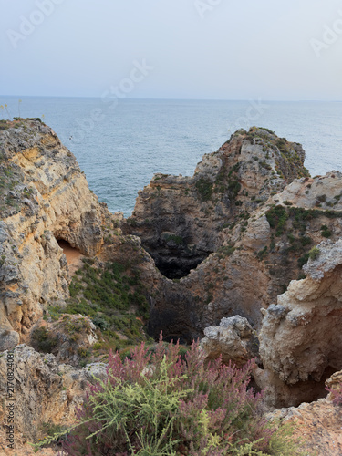 Rocky coastal cliffs and sea cave opening to Mediterranean water