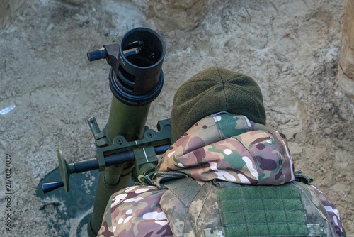 Принти на полотні Ukrainian soldier adjusting mortar sight in a trench