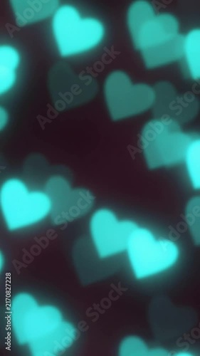 Soft blurred cyan heart-shaped bokeh lights glowing on a dark background, creating a romantic and dreamy abstract texture pattern for Valentine's Day or celebration design.