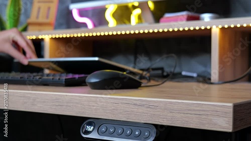 Remote worker closing laptop and tidying home office after work