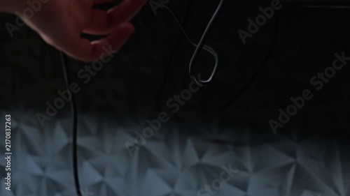 Close up of person raising electric standing desk with height control button