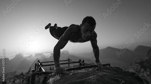 Athletic Man Performing Calisthenics Planche on Mountain Peak