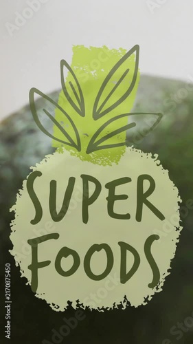 Super foods text animation over avocado, orange slice, and seeds on white background
