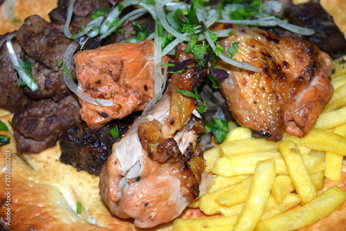 Traditional shashlik mixed platter with rice, fries, and flatbread
