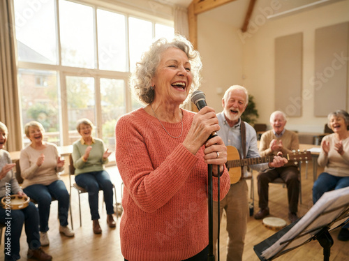 Senior Citizens Enjoying Music Session with Singing and Instruments in Bright Community Center Hall