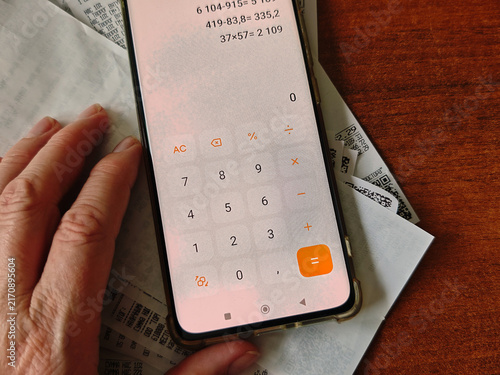 Calculating personal expenses at home using a calculator app for financial planning and budget control