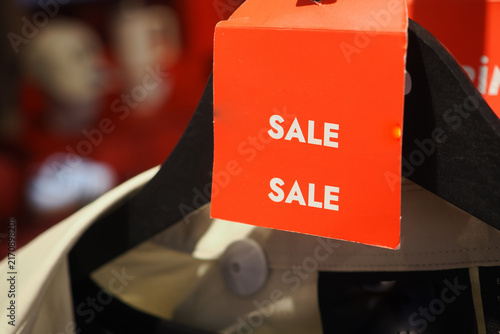 Fotografía Store sale sign on clothing rack in retail shop