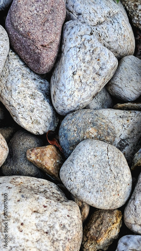 Photography Macro texture of multi colored river stones and pebbles background