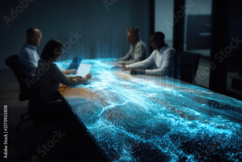 Business team in modern boardroom engaging with glowing digital data streams on table surface representing advanced technology and collaborative data