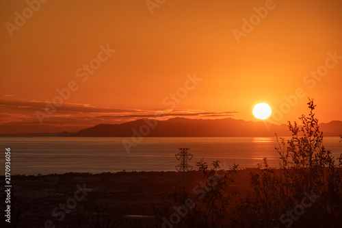 The sun setting into the sea