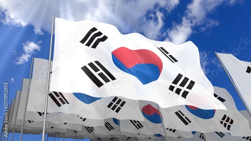 Multiple South Korea flags waving on blue sky