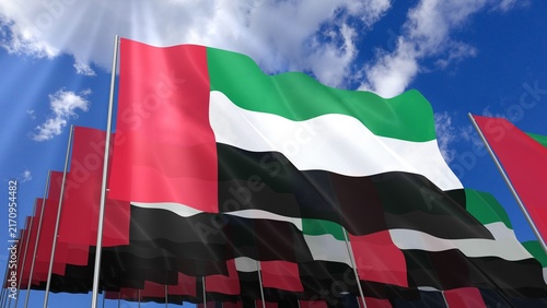 Multiple United Arab Emirates flags waving on blue sky