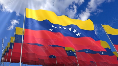Multiple Venezuela flags waving on blue sky
