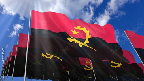 Multiple Angola flags waving on blue sky