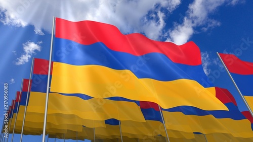 Multiple Armenia flags waving on blue sky