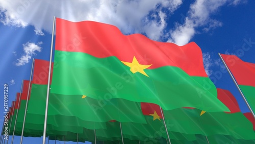 Multiple Burkina Faso flags waving on blue sky