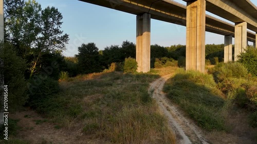 Aerial drone flying up over concrete highway viaduct bridge