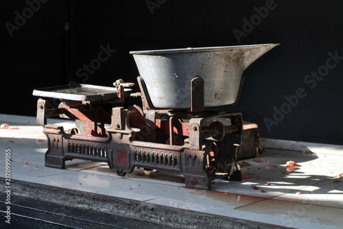 Vintage Cast Iron Balance Scale With Metal Bowl On Tiled Countertop