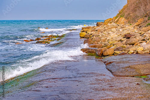 Peveril Point Swanage Dorset Rocky Shoreline With Waves Crashing Over Concrete Breakwater Along Coastal Sea Cliff