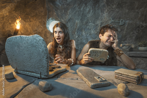 Canvastavla Funny Stone Age couple doing online shopping at home