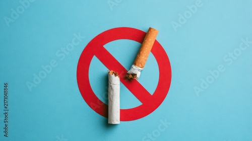 Conceptual image of no smoking policy with cigarettes and red prohibition sign on light blue background, promoting health awareness and anti-smoking campaign