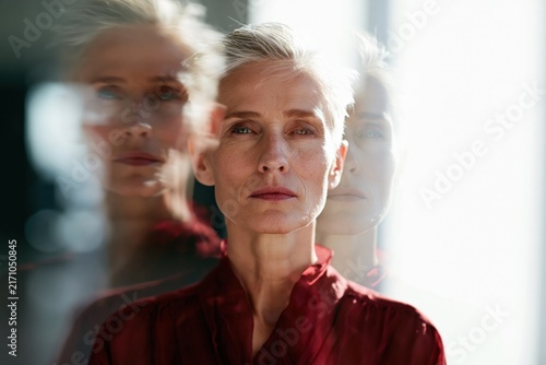 Senior woman portrait with layered reflection and threefold double exposure effect for moody editorial background and banner design