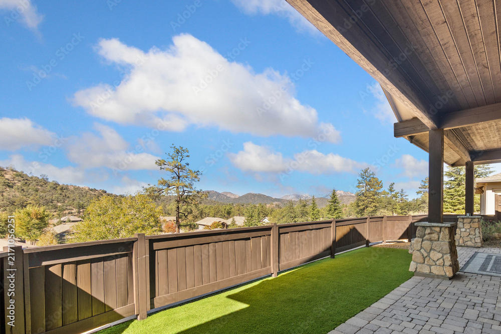 Naklejka premium Balcony view with wooden railing and blue sky