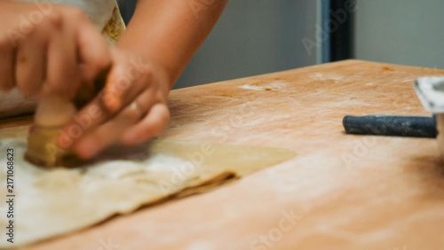 Bild auf Leinwand Artisan hands preparing traditional Bolognese tortelli on a wooden board, shapin