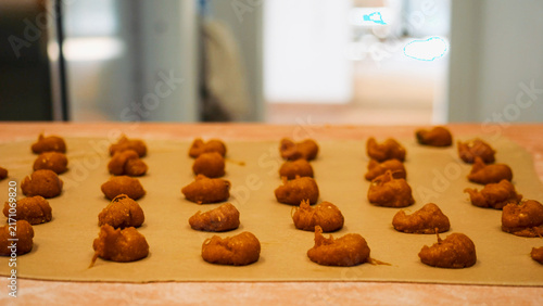 фотографія Rows of freshly made tortelli dough are neatly arranged on parchment paper, read