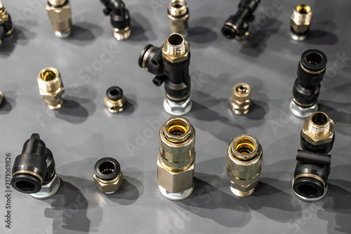 Fotografie Assortment of pneumatic push-to-connect fittings, quick disconnect couplers, and