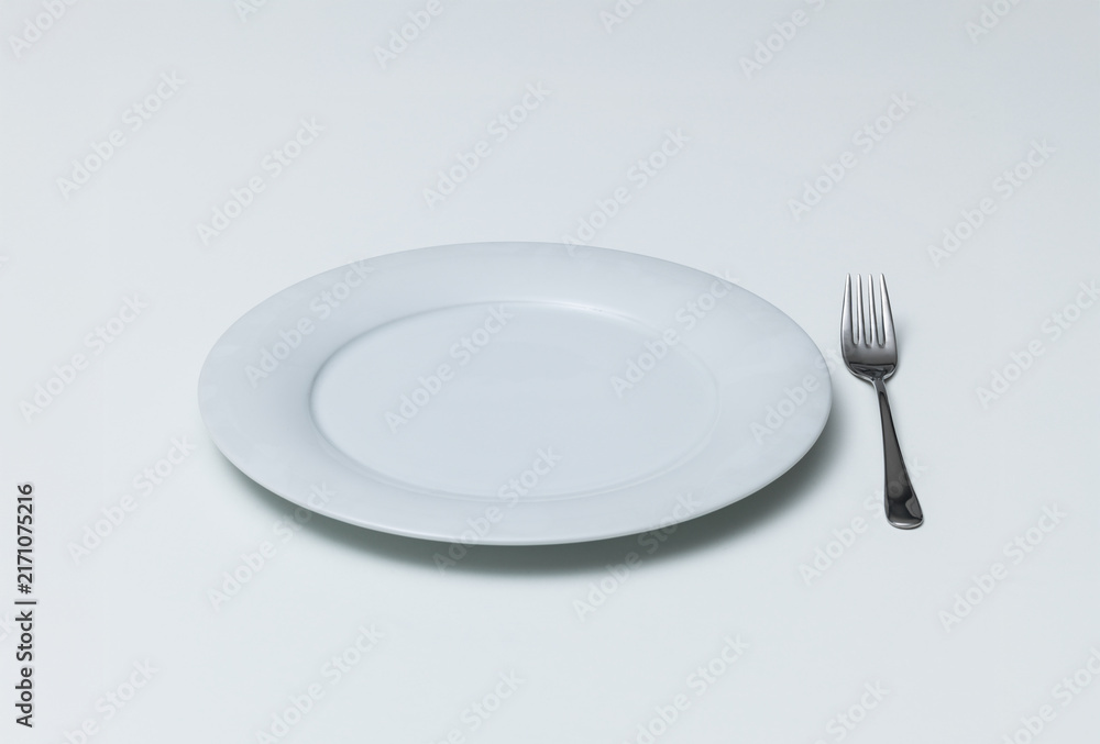 Fototapeta premium Empty Ceramic Plate with Silver Fork on White Background