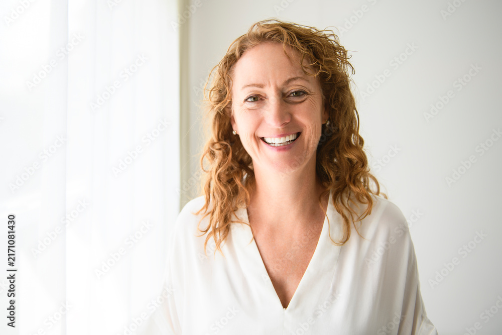 Obraz premium Happy mature woman on studio white background with nice portrait