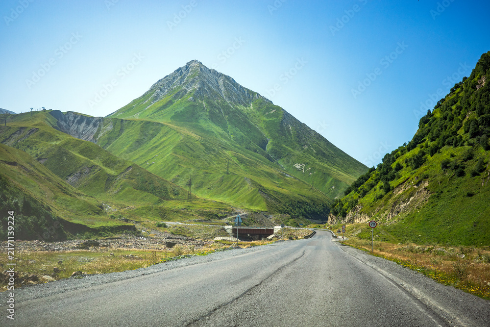 Naklejka premium Georgia mountain road Caucasus highlands scenic highway green peak travel, empty asphalt route through summer landscape, tourism, adventure, mobility and driving.