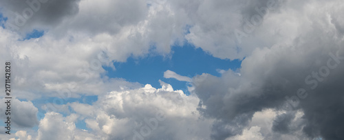 Obraz na plátne Dense white clouds with glimpse of blue sky during day