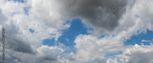 Obraz na plátne Dense white clouds with glimpse of blue sky during day